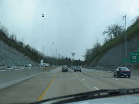 1995 Ford C-350 (Centurion Conversions) - Driving on a highway with multiple lanes and traffic under an overcast sky.