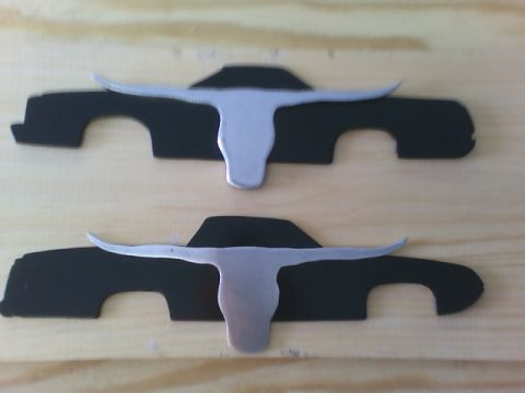 1979 Ford Ranchero - Car profile cutouts with steer horn emblems are displayed on a wooden surface.