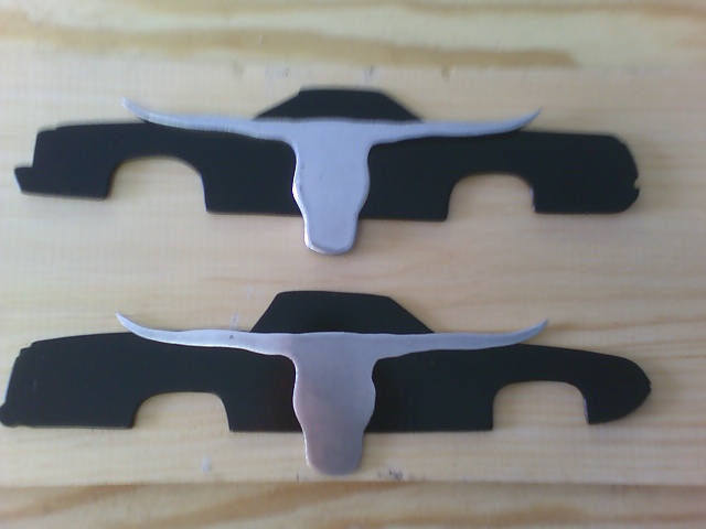 Two black car profile cutouts, each with a silver steer horn emblem