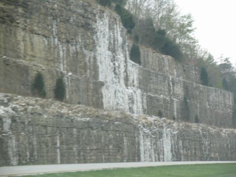 1995 Ford C-350 (Centurion Conversions) - A scenic view of a rock face with icicles and sparse trees, likely captured during a road trip.