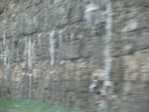 1995 Ford C-350 (Centurion Conversions) - Blurred motion captures a rock face with icicles, suggesting a roadside scene.
