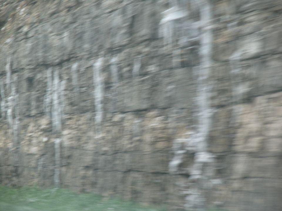 Rock face with icicles hanging down, blurred motion