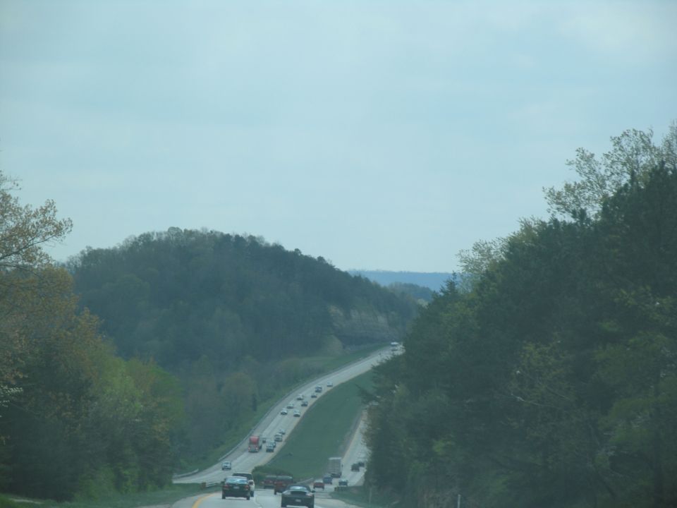Highway with multiple vehicles driving on a cloudy day