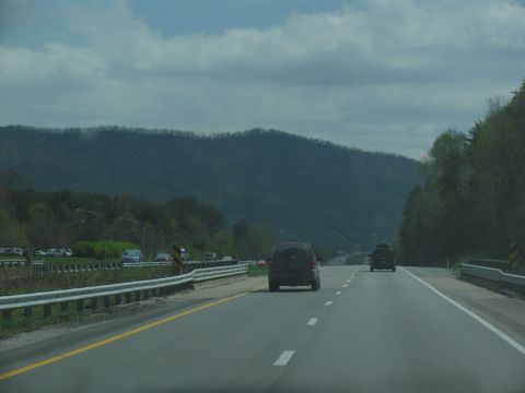 1995 Ford C-350 (Centurion Conversions) - Driving on a highway with other vehicles and a mountainous landscape in the background.