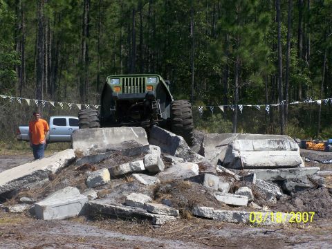 1989 Ford Bronco - An off-road vehicle navigates a challenging obstacle course made of concrete debris.
