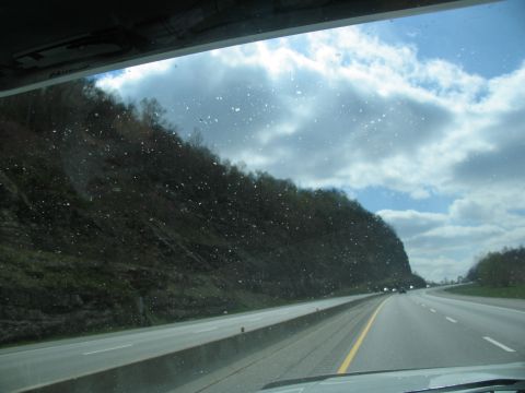 1995 Ford C-350 (Centurion Conversions) - Driving on a highway with trees lining the road under a cloudy sky.