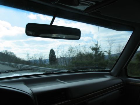1995 Ford C-350 (Centurion Conversions) - View from inside a vehicle on a road trip, looking out the windshield at the passing scenery.