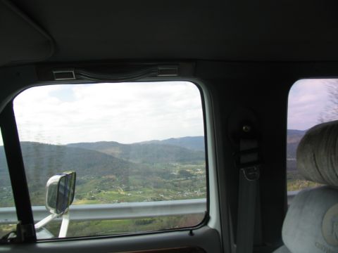 1995 Ford C-350 (Centurion Conversions) - Looking out the window at a scenic view of rolling hills and a valley below.