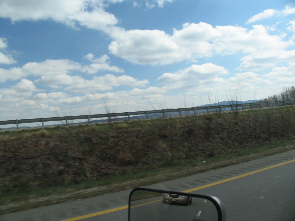 Car reflected in side mirror, seen from a vehicle on a highway