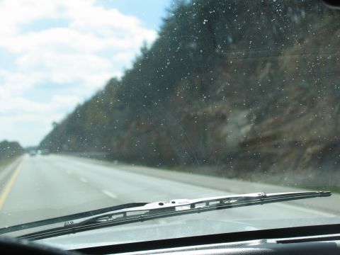 1995 Ford C-350 (Centurion Conversions) - View from inside a vehicle on a highway, with a windshield wiper visible.
