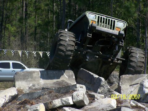 1989 Ford Bronco - A monster truck navigates a course of concrete obstacles.
