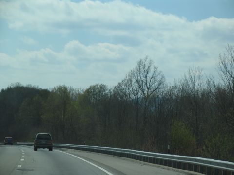 1995 Ford C-350 (Centurion Conversions) - Vehicles on a highway during daytime with trees lining the road.