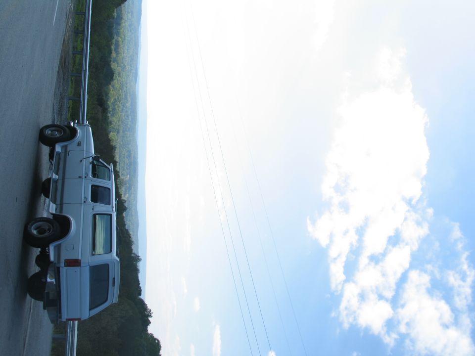 White 1995 Ford C-350 Centurion Conversions van parked roadside with scenic view