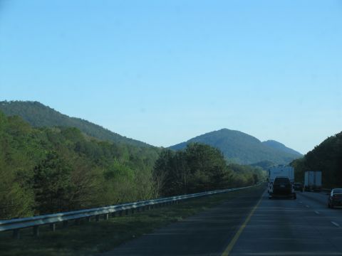 1995 Ford C-350 (Centurion Conversions) - View from a car on a highway, with trees and mountains visible.