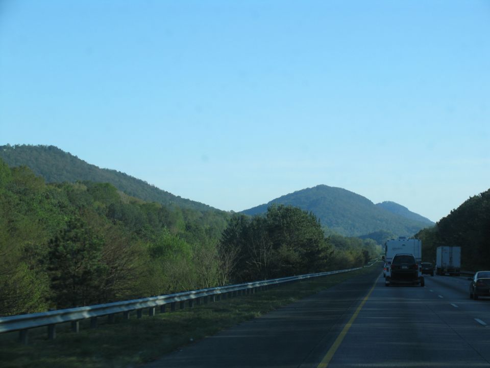 Driving on a highway with mountains in the background
