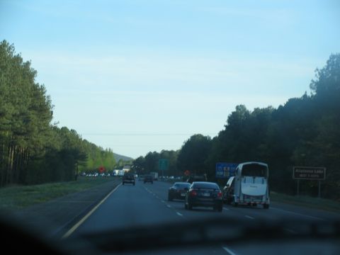 1995 Ford C-350 (Centurion Conversions) - A white horse trailer is seen from behind on a highway with other vehicles.