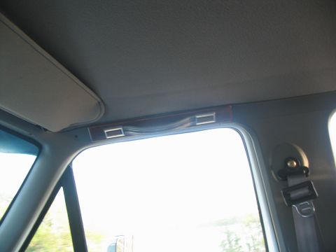 1995 Ford C-350 (Centurion Conversions) - Close-up of a vehicle's interior grab handle above the window.
