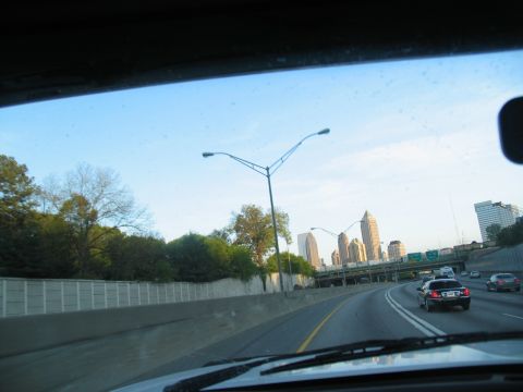 1995 Ford C-350 (Centurion Conversions) - View from a vehicle driving on a highway with a city skyline in the distance.
