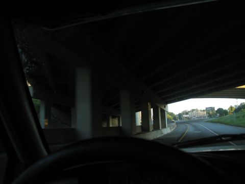 1995 Ford C-350 (Centurion Conversions) - View from inside a vehicle driving under an overpass on a highway.