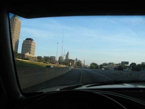 1995 Ford C-350 (Centurion Conversions) - Driving towards a city skyline with tall buildings visible in the distance.