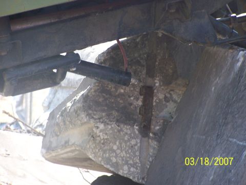 1989 Ford Bronco - The underside of a vehicle is visible, supported by large rocks, with a timestamp indicating the photo was taken on March 18, 2007.