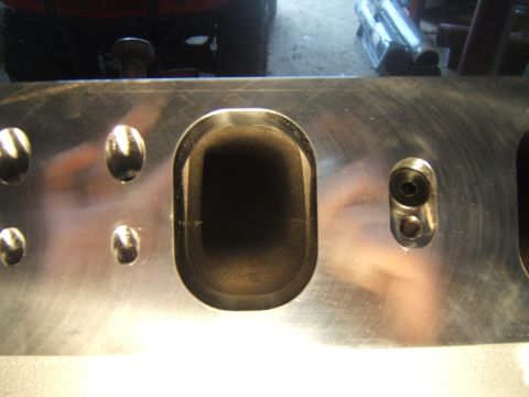 1980 Ford F-250 - Engine cylinder head with visible intake ports and bolt holes.