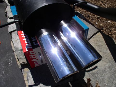 1996 Ford Probe - Dual exhaust tips are shown close-up, with a Makita angle grinder box visible beneath.