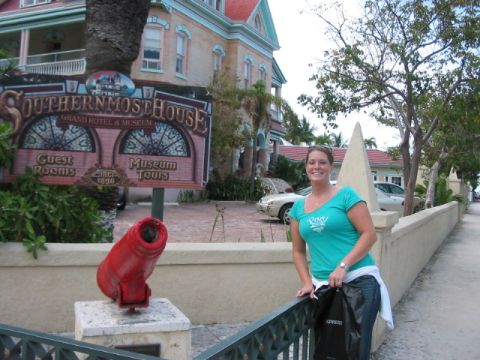 1991 Ford Bronco - Woman poses in front of the historic Southernmost House hotel, with a vintage car visible.