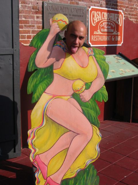 1991 Ford Bronco - A person poses with a cutout of a woman in a yellow bikini at Casa Cayo Hueso Restaurant & Bar.