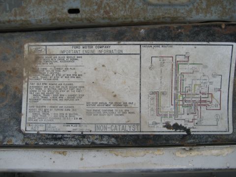 1986 Ford Bronco - Underhood VECI emission label (non-catalyst) with ignition timing, fast/curb idle specs and vacuum hose routing diagram for a 1985 heavy-du…