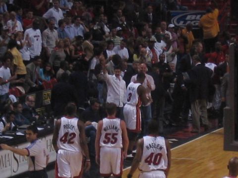 1991 Ford Bronco - Basketball players walk onto the court during a game, with spectators in the stands.