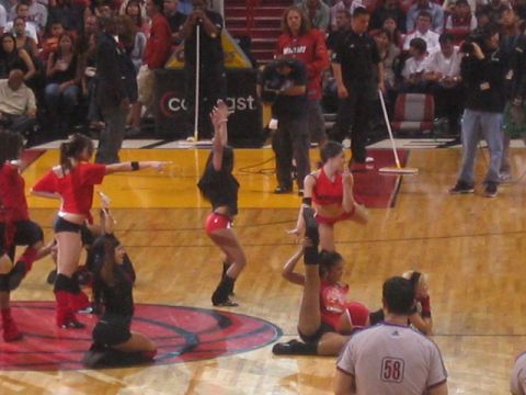 1991 Ford Bronco - A group of cheerleaders performs during a basketball game, with audience members visible in the stands.