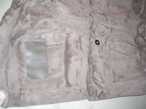 2003 Ford Crown Victoria - Car carpet with a clear plastic mat and a black grommet visible.