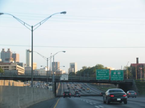 1995 Ford C-350 (Centurion Conversions) - Traffic moves along a highway with signs for Williams St, Aquarium, Georgia Dome, North Ave, and Georgia Tech.