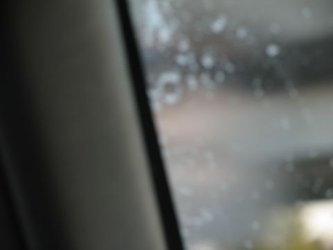 1995 Ford C-350 (Centurion Conversions) - Looking out the window from the passenger seat, the glass has water spots obscuring the view.