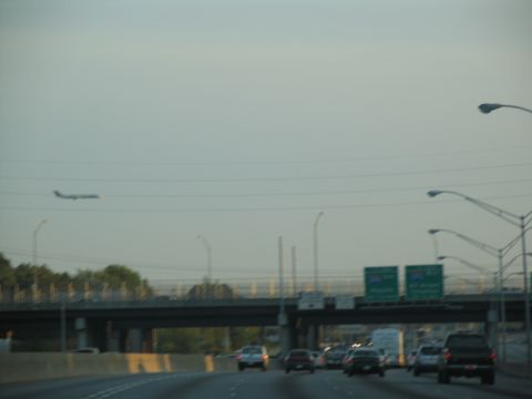 1995 Ford C-350 (Centurion Conversions) - Highway scene with traffic and an airplane in the distance.