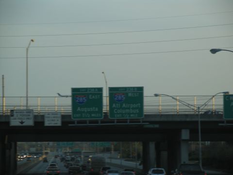 1995 Ford C-350 (Centurion Conversions) - Signs indicate exits for Augusta and Atlanta Airport on I-285. Traffic moves below the overpass.