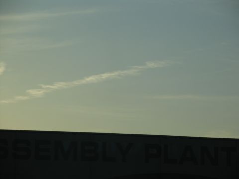 1995 Ford C-350 (Centurion Conversions) - Building with 'ASSEMBLY PLANT' text visible against a sky with a contrail.