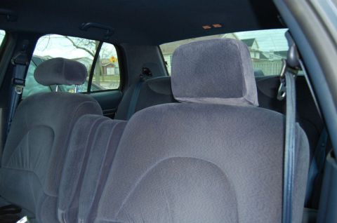 1985 Mercury Grand Marquis - View of the rear interior seats and headrests, showing the fabric upholstery and seatbelts.