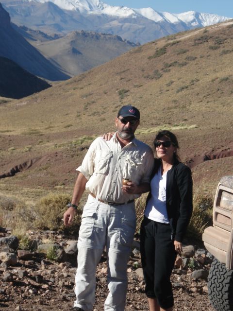 1986 Ford Bronco - A couple poses in front of a 1986 Ford Bronco with a scenic mountain backdrop.