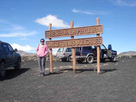 1986 Ford Bronco - Woman at Reserva La Payunia, Circuito Los Volcanes, with multiple SUVs parked nearby.