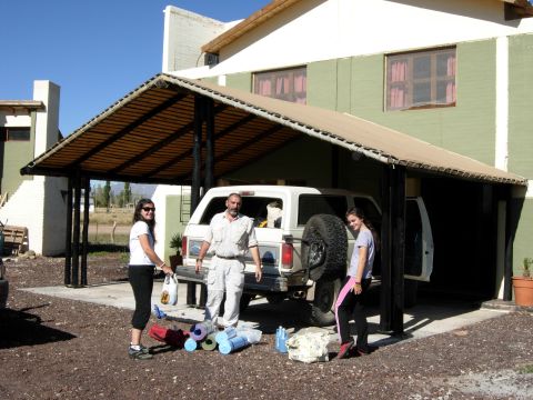 1986 Ford Bronco - A white 1986 Ford Bronco is parked under a carport with a family standing nearby.