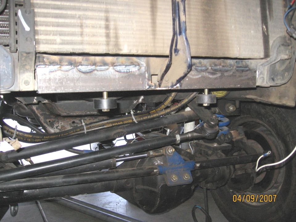 Custom radiator support bracket with shocks and tie rods visible