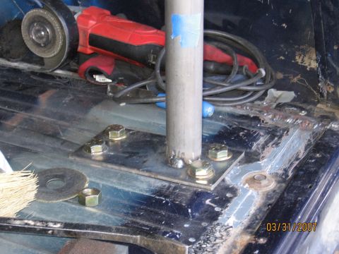 1994 Ford Bronco - A metal pole is being installed inside a vehicle, with tools and hardware visible.