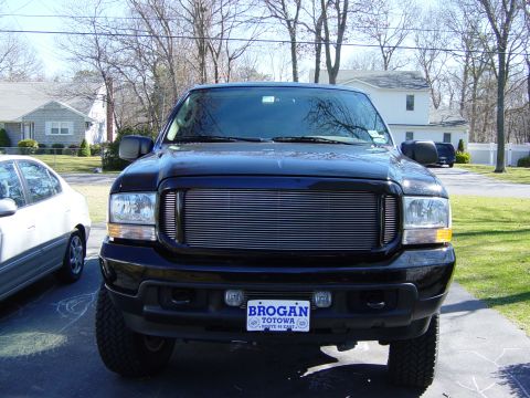 2004 Ford Excursion - Front view of a black 2004 Ford Excursion, a prominent chrome grille and license plate.