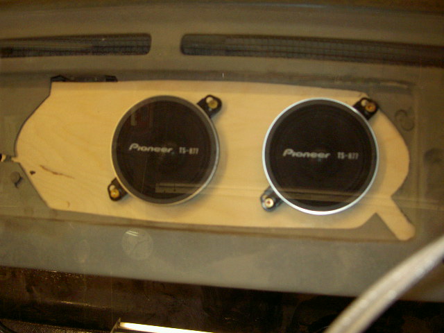 Two Pioneer TS-411 speakers mounted on a wooden panel in a vehicle's dashboard