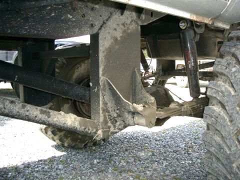 1991 Chevrolet Suburban - Undercarriage view of a vehicle's rear axle, suspension components, and tire.