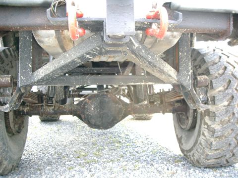 1991 Chevrolet Suburban - Underside view of a vehicle's rear axle and suspension system with large tires.