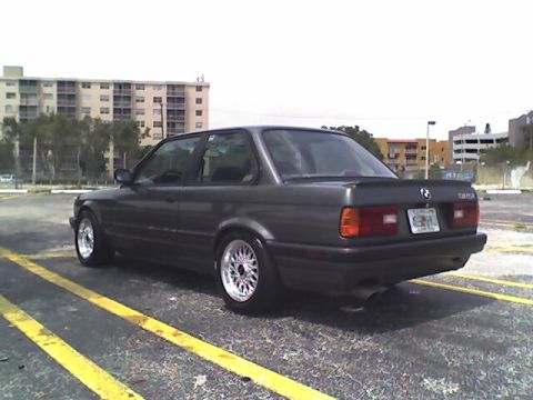 1989 BMW 3 Series - This 1989 BMW 3 Series coupe is shown from the rear 3/4 angle, aftermarket wheels and a spoiler.