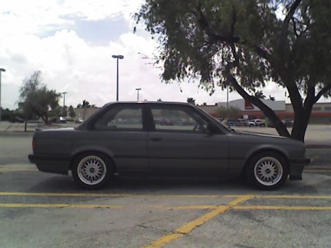 1989 BMW 3 Series - A gray BMW 3 Series coupe is parked under a tree in a parking lot.
